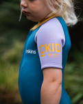 The C-Skins Girls NuWave C-Kid Baby Front Zip Shorty Wetsuit in Steel Blue & Lilac