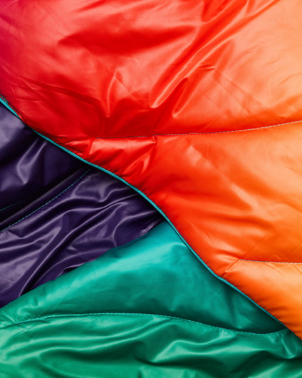 The Rumpl Original Puffy Blanket in Rainbow Prism